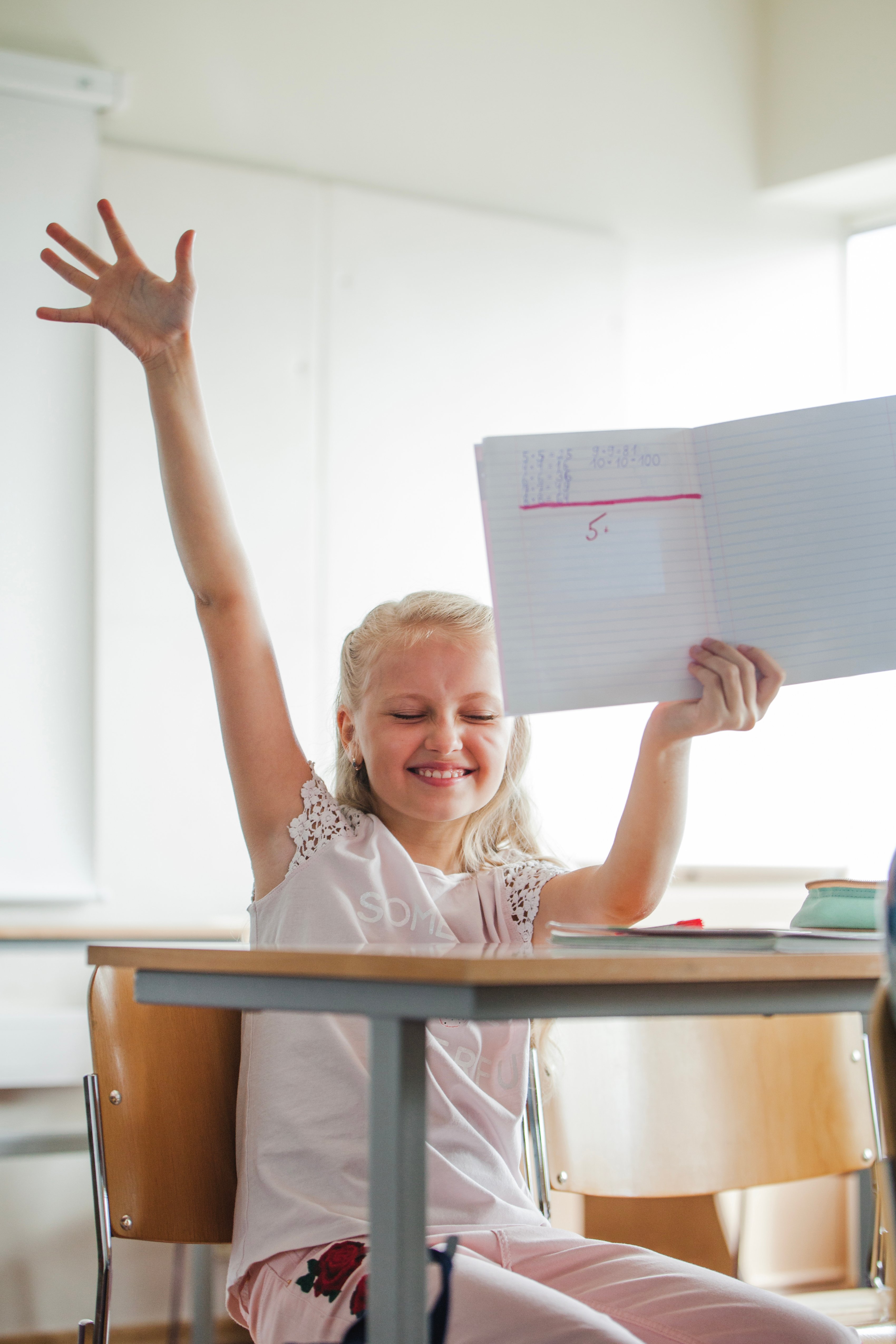 girl-sitting-school-table-with-notebook