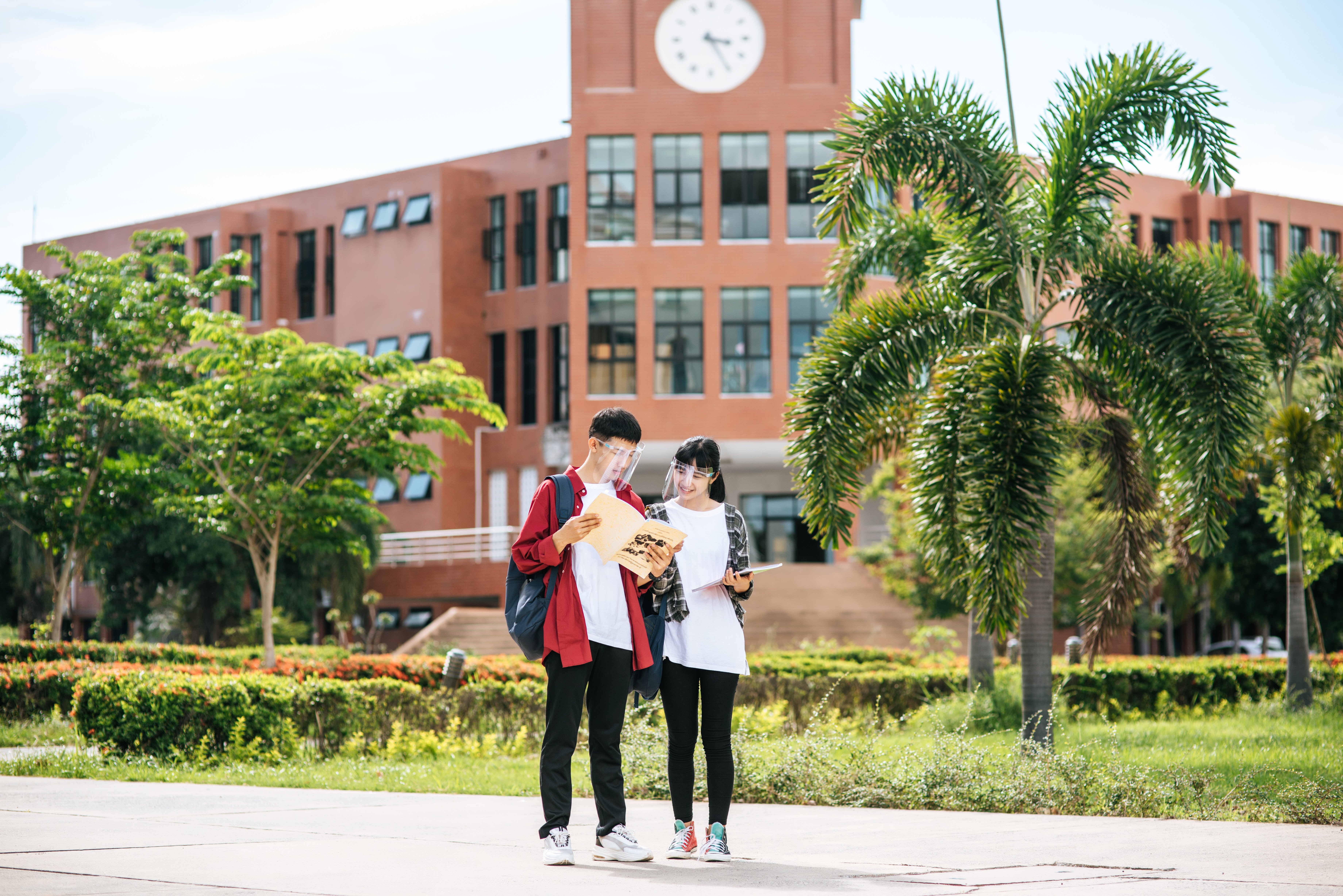 male-female-students-wear-face-chill-stand-front-university